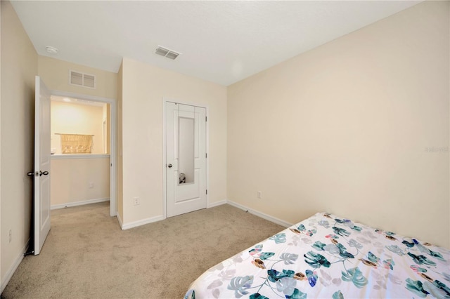 bedroom featuring a closet and light colored carpet