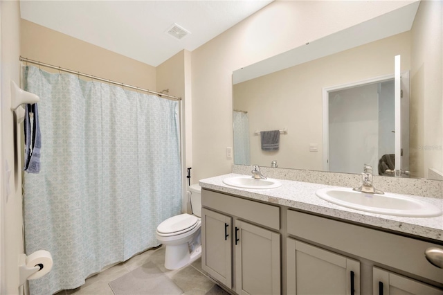 bathroom with tile patterned flooring, toilet, walk in shower, and vanity