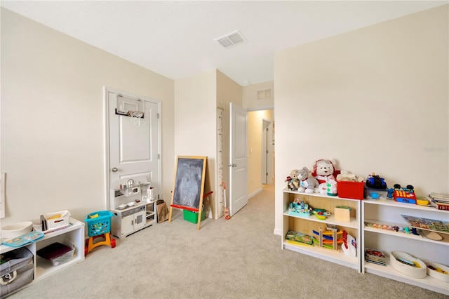 recreation room with light colored carpet