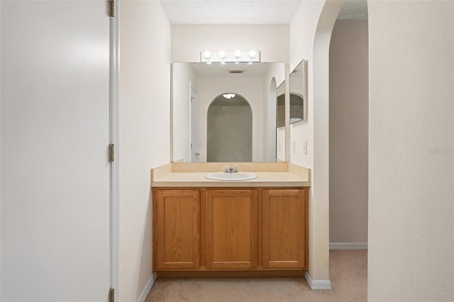 bathroom featuring a textured ceiling and vanity