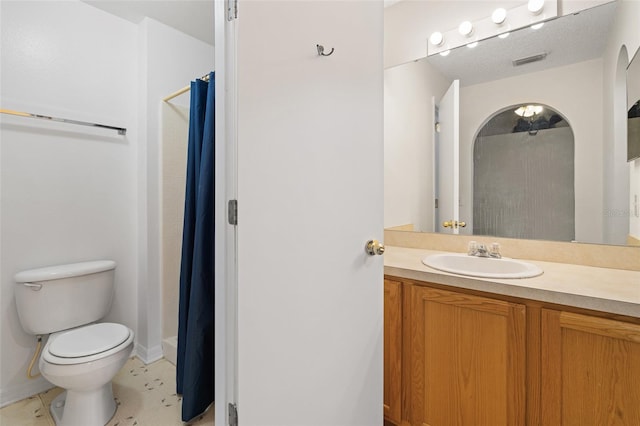 bathroom with vanity, toilet, and a shower with shower curtain