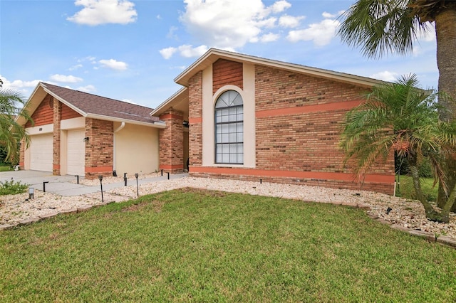 view of front facade with a front lawn, an attached garage, and brick siding