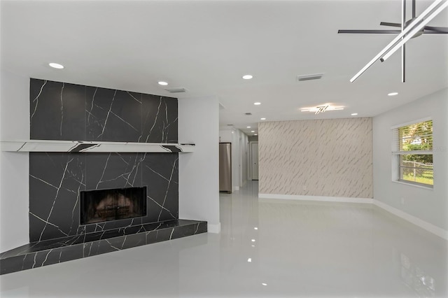 kitchen with a high end fireplace, ceiling fan, and stainless steel refrigerator