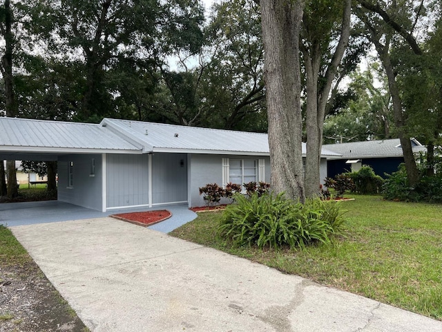 ranch-style house with a front yard and a carport