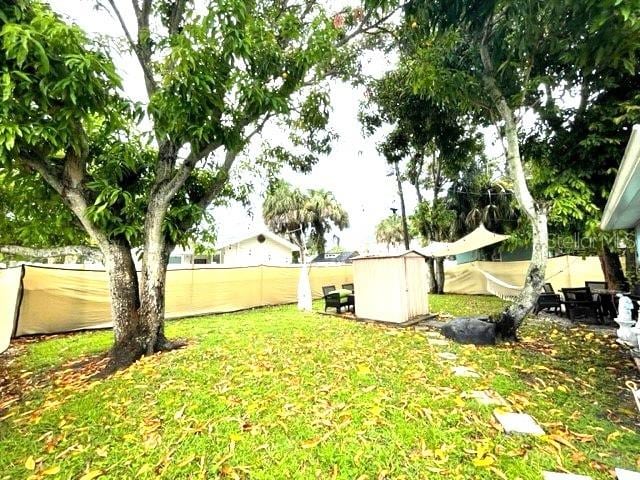 view of yard featuring a storage unit