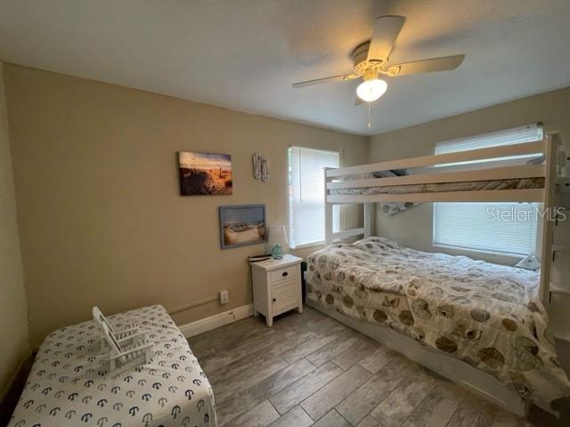 bedroom featuring ceiling fan and wood-type flooring