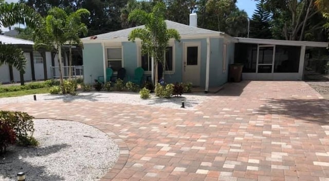 back of house featuring a sunroom