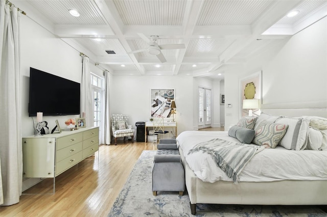 bedroom with coffered ceiling, ceiling fan, beam ceiling, and light hardwood / wood-style flooring