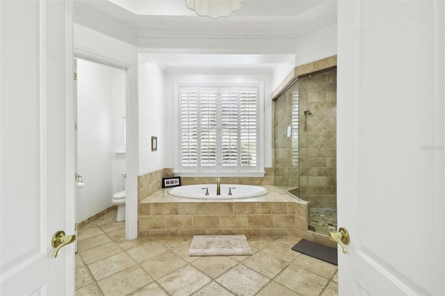 bathroom featuring toilet, ornamental molding, and independent shower and bath