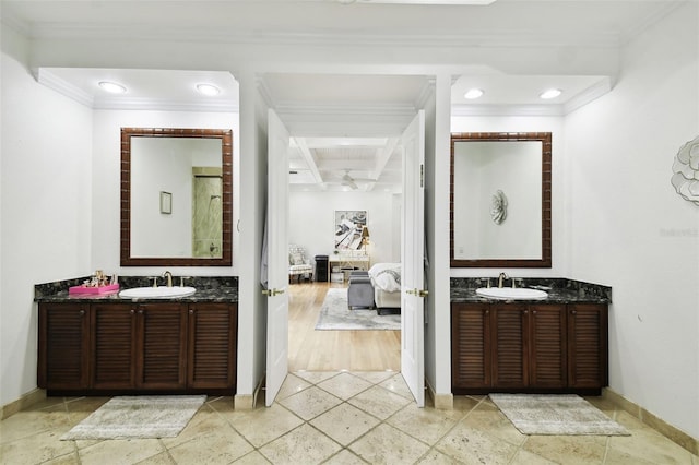 bathroom with crown molding, vanity, and hardwood / wood-style floors