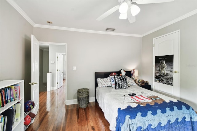 bedroom with crown molding, ceiling fan, and dark hardwood / wood-style floors