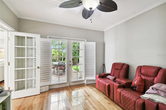 living room with light wood-type flooring, ceiling fan, crown molding, and french doors