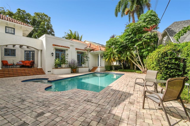 view of swimming pool with a wooden deck and a patio area