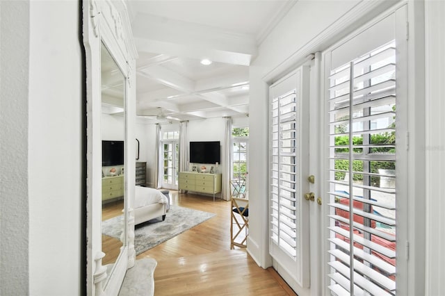 doorway to outside with coffered ceiling, ornamental molding, light hardwood / wood-style flooring, ceiling fan, and beam ceiling