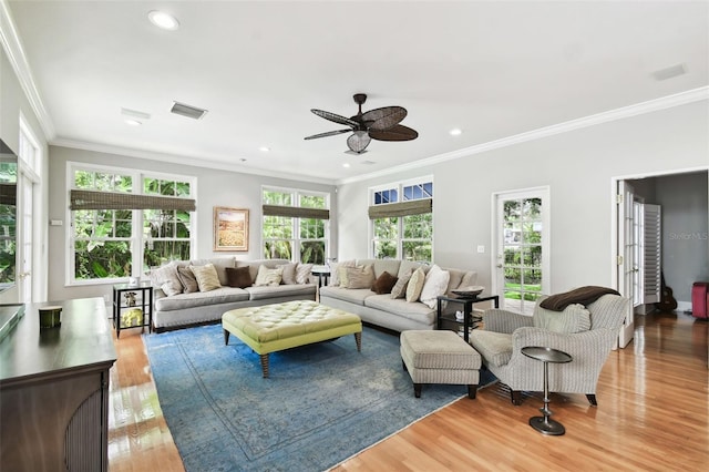 living room featuring crown molding, plenty of natural light, ceiling fan, and hardwood / wood-style floors