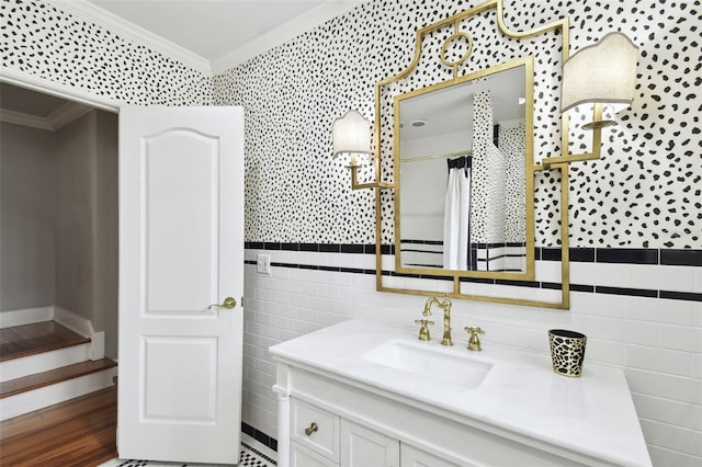 bathroom featuring ornamental molding, vanity, tile walls, and hardwood / wood-style floors