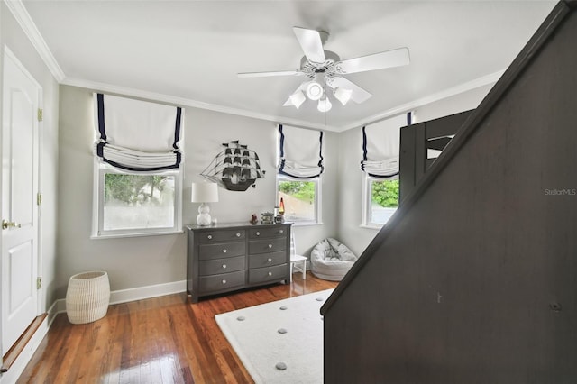 bedroom featuring crown molding, dark wood-type flooring, and ceiling fan