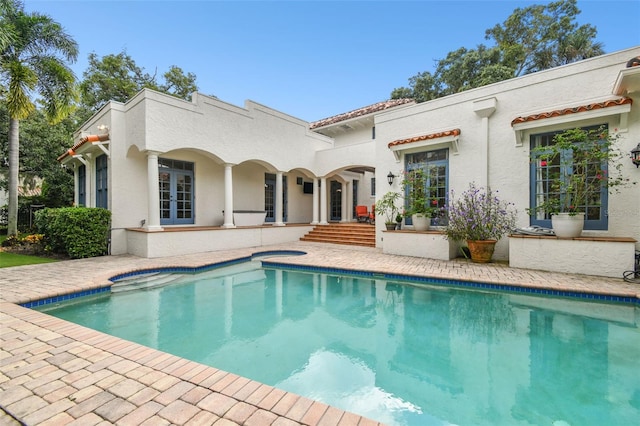 rear view of house featuring french doors and a patio area