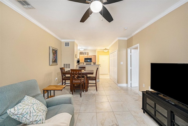 tiled living room featuring ceiling fan and ornamental molding