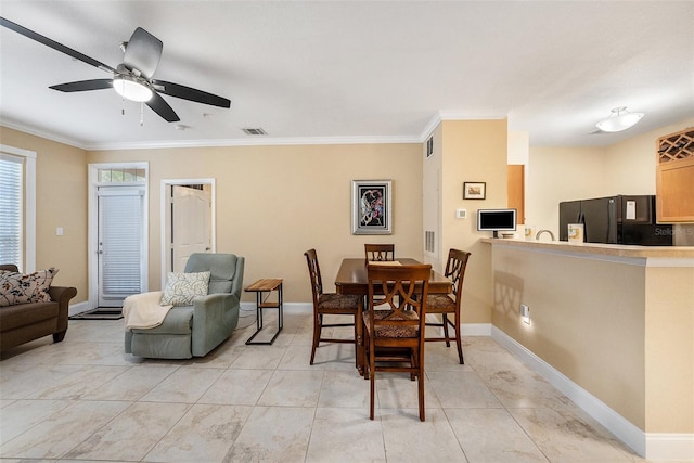 dining area with ceiling fan, ornamental molding, and light tile patterned flooring