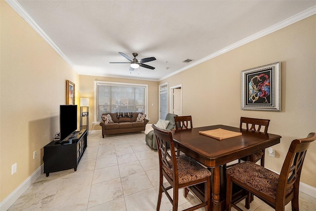 dining room with crown molding and ceiling fan