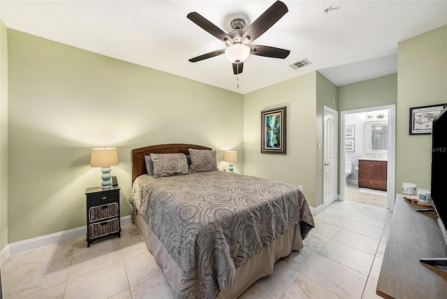 5000 Culbreath Key Way Unit 1-212, Tampa, FL 33611 - bedroom featuring baseboards, ensuite bathroom, ceiling fan, and light tile patterned flooring