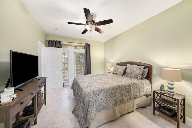 tiled bedroom with ceiling fan and access to exterior