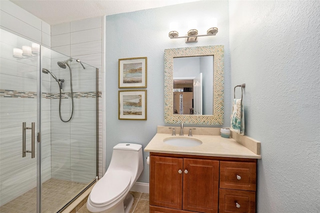 bathroom with vanity, toilet, a textured ceiling, and an enclosed shower