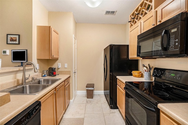5000 Culbreath Key Way Unit 1-212, Tampa, FL 33611 - kitchen with black appliances, a sink, light brown cabinets, light countertops, and baseboards