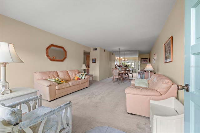 living room with light colored carpet and an inviting chandelier