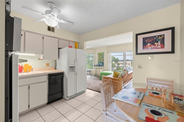 kitchen featuring white fridge with ice dispenser, white cabinetry, a textured ceiling, dishwasher, and ceiling fan