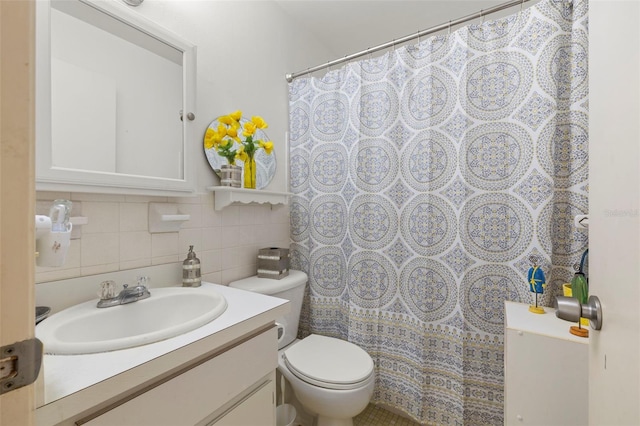 bathroom with toilet, vanity, tasteful backsplash, tile walls, and a shower with shower curtain