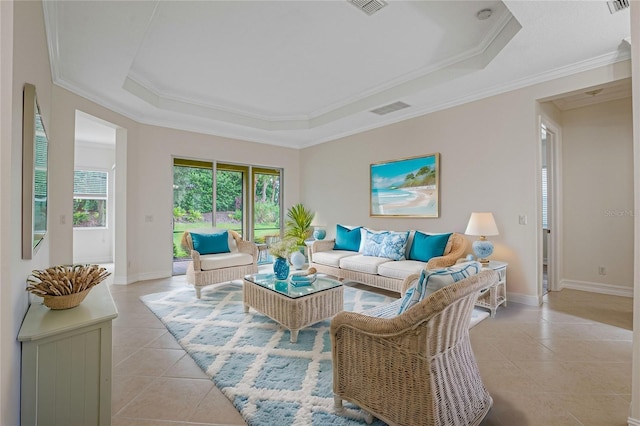 tiled living room with ornamental molding and a raised ceiling