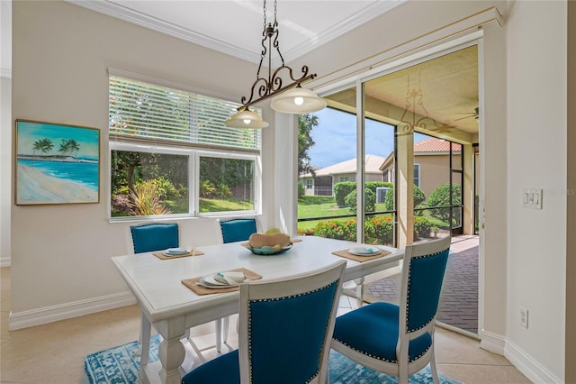 dining space featuring crown molding and light tile patterned floors