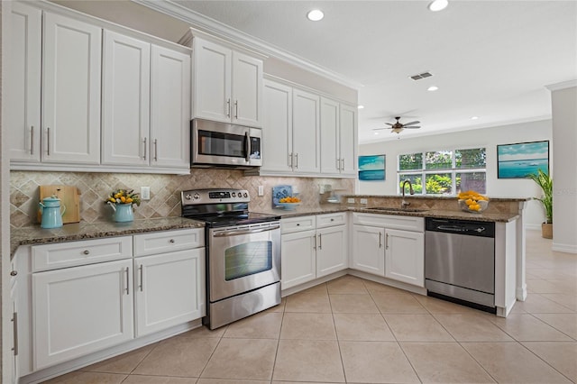 kitchen featuring white cabinetry, kitchen peninsula, sink, ceiling fan, and appliances with stainless steel finishes