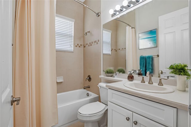 full bathroom with toilet, shower / tub combo with curtain, and vanity