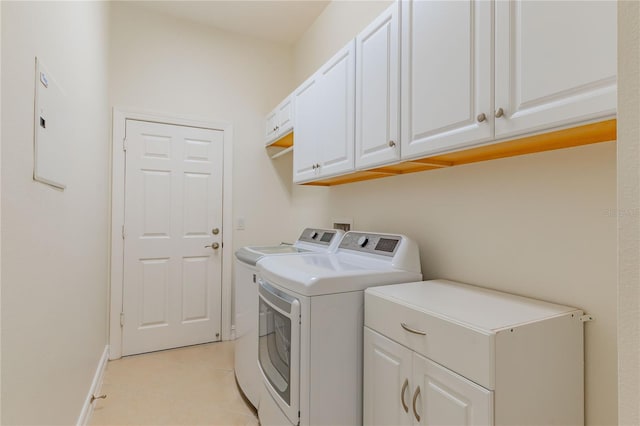 washroom with cabinets and washer and dryer