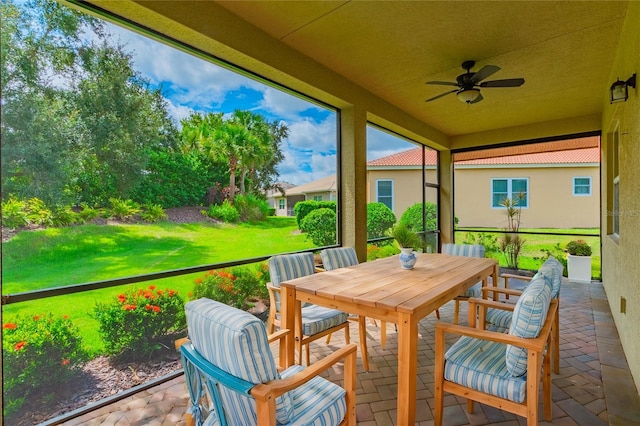 sunroom featuring ceiling fan