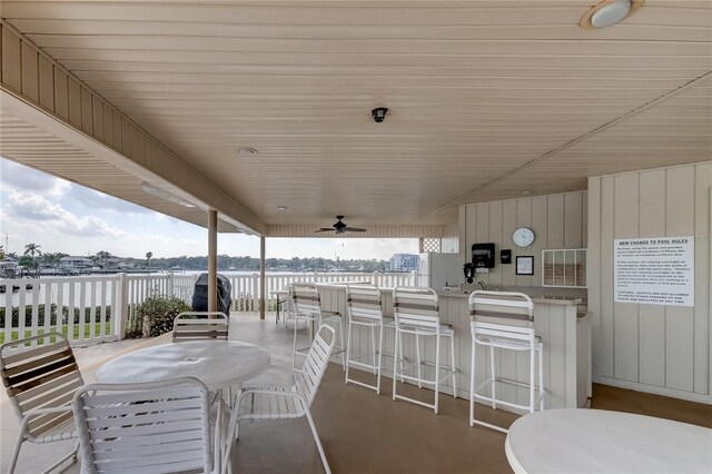 view of patio / terrace featuring ceiling fan and a water view