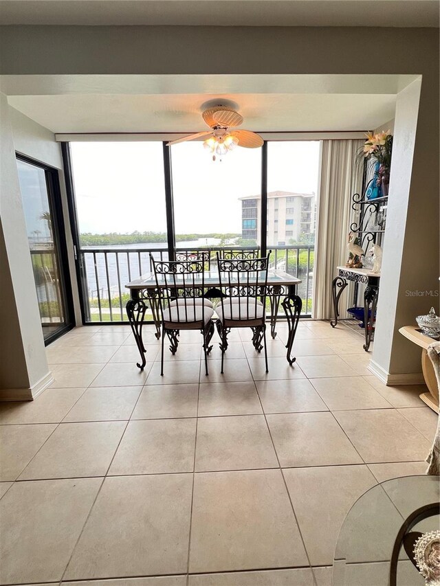 tiled dining space with ceiling fan