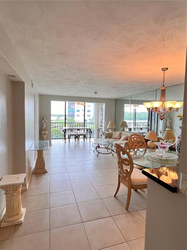 tiled dining space with a chandelier