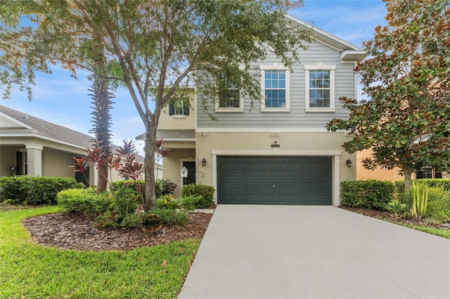 traditional-style home featuring driveway, a garage, and stucco siding