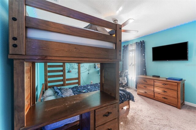 carpeted bedroom with ceiling fan and multiple windows