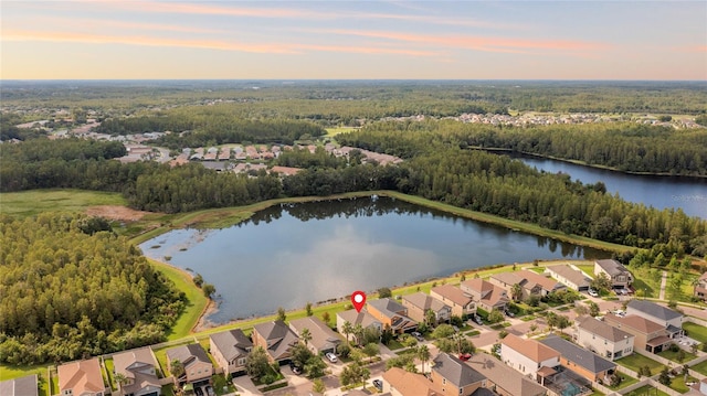 drone / aerial view with a water view, a forest view, and a residential view