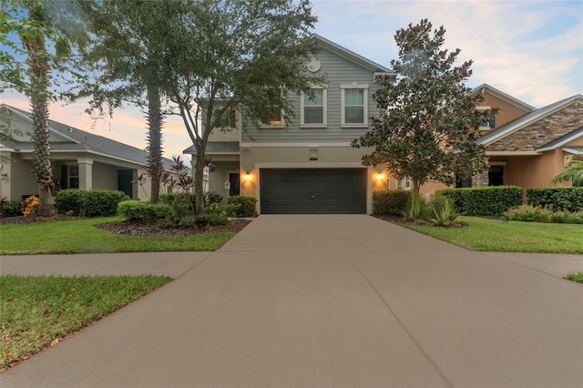 view of front facade with a garage and a yard