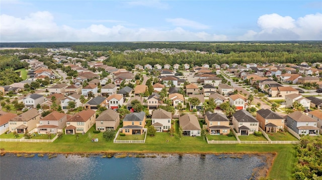 birds eye view of property with a water view and a residential view