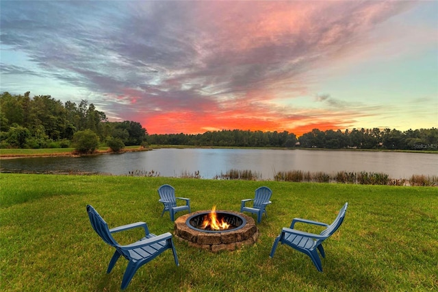 view of yard with a fire pit and a water view