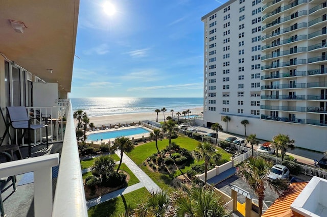 balcony featuring a water view and a beach view