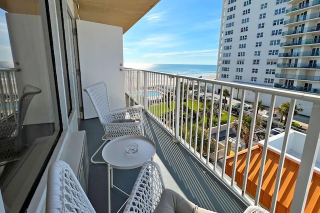 balcony with a beach view and a water view