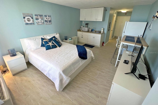 bedroom featuring white refrigerator